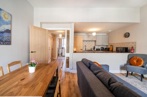 a living room with a couch and a wooden table at 2 Bed Flat - Town Centre in Paisley