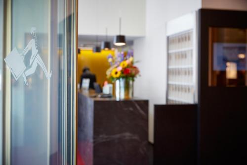a glass door with an arrow sign on it at Hotel Schweizerhof St. Moritz in St. Moritz