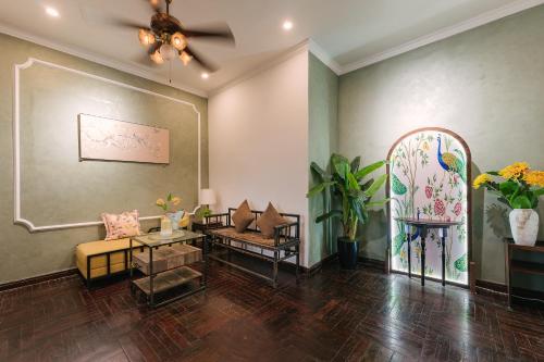 a living room with a couch and a table at Villaxe Legume, 50m to Hoan Kiem lake - by Antique in Hanoi