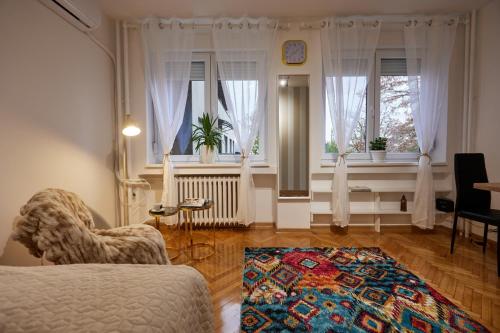 a living room with a bed and a window at Best choice Hram centar in Belgrade