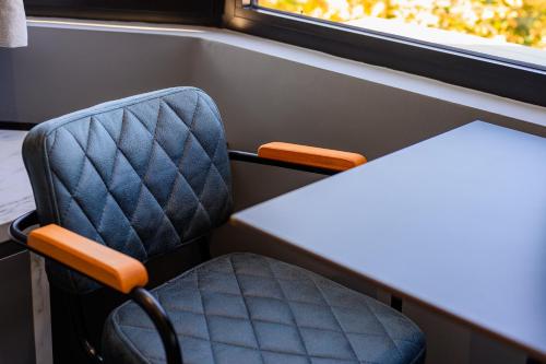 a table and a chair in a train room at Adore Home in Tirana