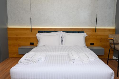 a bed with white sheets and pillows in a room at Adore Home in Tirana