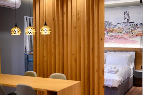 a room with a bed and a table with chairs at Adore Home in Tirana