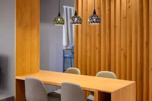 a conference room with a wooden table and chairs at Adore Home in Tirana
