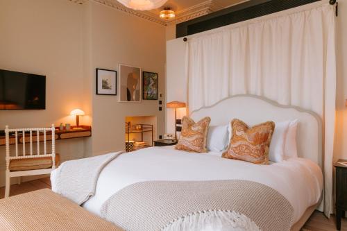 a bedroom with a large white bed with pillows at No.124 by GuestHouse, Brighton in Brighton & Hove