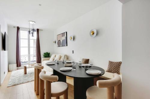 une salle à manger avec une table et des chaises noires dans l'établissement Saint Michel - Notre Dame, à Paris