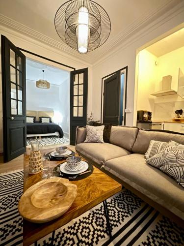 un salon avec un canapé et une table dans l'établissement L'Art appart' - T2 - Lit King Size - Proche centre, à Amiens