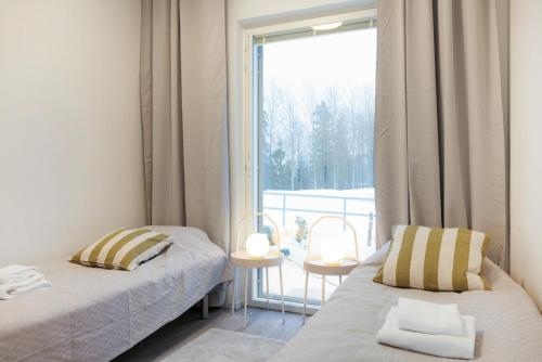 Ένα ή περισσότερα κρεβάτια σε δωμάτιο στο Forenom Serviced Apartments Espoo Saunalahti