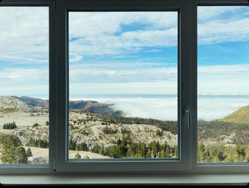 a window with a view of a mountain view at BÈTH CÈU - 4 PERS - Appart vacances- in Arette