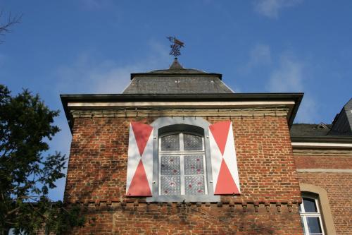 a window on the side of a brick building at Burg Wassenberg in Wassenberg