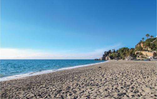 a sandy beach with the ocean in the background at Pet Friendly Home In Malaga in Málaga