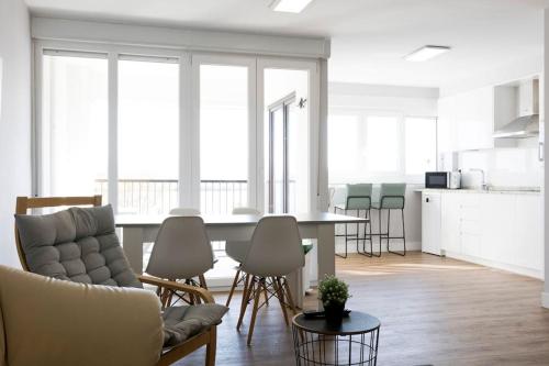 a living room and kitchen with a table and chairs at Goizalde - Basquenjoy in Fuenterrabía