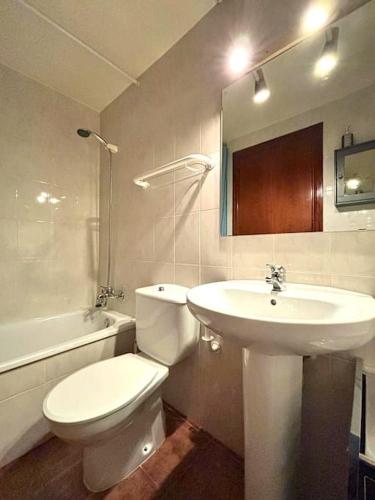 a bathroom with a white toilet and a sink at Dúplex de muntanya amb vistes by RURAL D'ÀNEU in Esterri d'Àneu