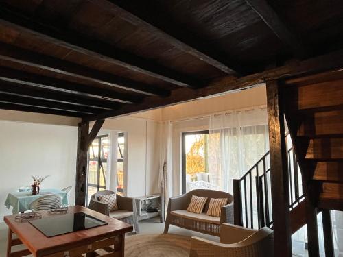 a living room with a table and chairs at COCO MANGO Villa in Trèfles