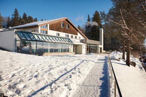 a building with snow on the ground in front of it at Reka-Feriendorf Montfaucon in Montfaucon
