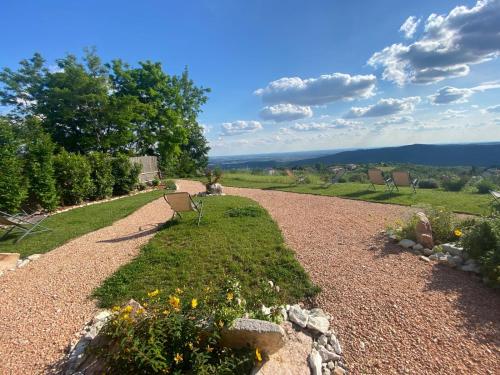 a gravel path with a bench in a garden at Agriturismo La Perlara - Adults Only in Verona