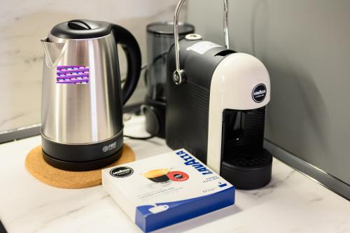 a coffeemaker and a coffee maker on a counter at Adore Home in Tirana