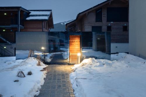a door to a house in the snow at BASECAMP Reiteralm in Schladming
