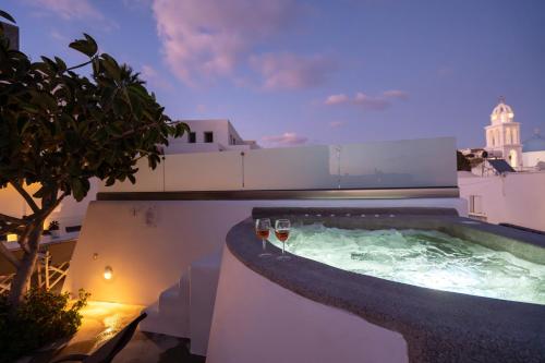 two glasses of wine in a hot tub on a building at NEW Yiota Collection 4 Suites & 4 Prive Jacuzzi in Megalokhori