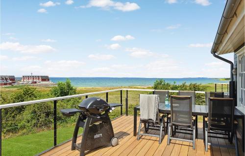 a balcony with a table and chairs and the ocean at Holiday Home Strandgårdsvej Bagenkop X in Bagenkop