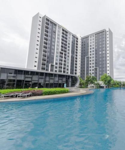 a large building next to a large body of water at 3 Room SplashMania Maya Bay Gamuda Cove Near KLIA in Banting