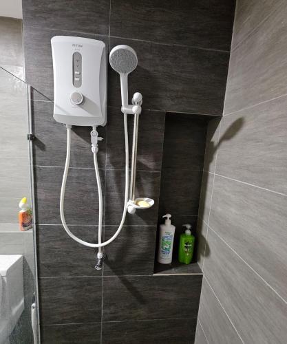 a shower in a bathroom with a hair dryer at 3 Room SplashMania Maya Bay Gamuda Cove Near KLIA in Banting