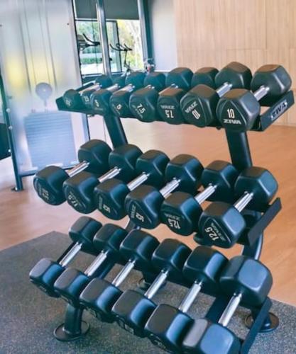 a rack of dumbbells in a gym at 3 Room SplashMania Maya Bay Gamuda Cove Near KLIA in Banting