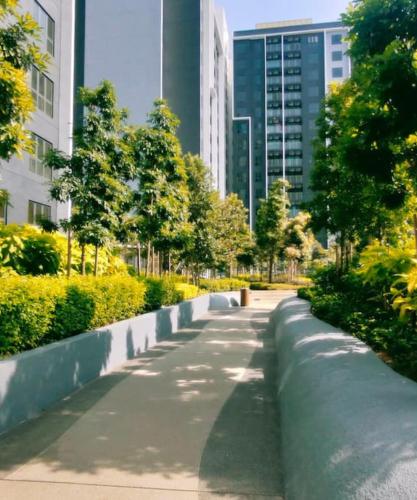 a walkway in a city with tall buildings at 3 Room SplashMania Maya Bay Gamuda Cove Near KLIA in Banting