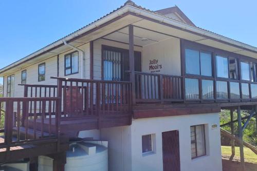 a large house with a large balcony on top of it at Jolly Mooi's Beach Break in Gxara