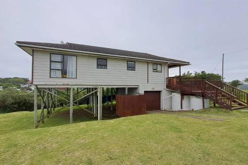 a house with a large yard with a deck at Jolly Mooi's Beach Break in Gxara