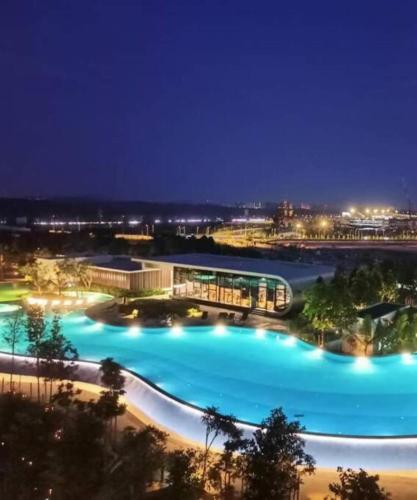 a view of a large pool at night at 3 Room SplashMania Maya Bay Gamuda Cove Near KLIA in Banting