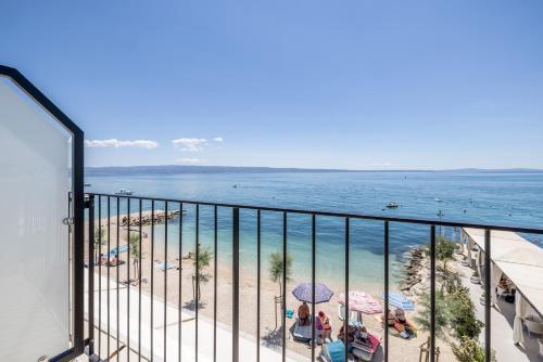 a balcony with a view of the beach and the ocean at Hotel Aria in Podstrana