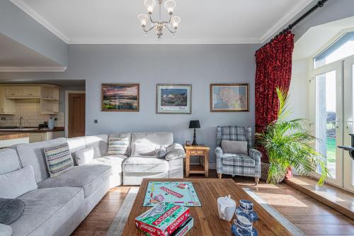 a living room with a couch and a table at Snowdonia View in Llanfairpwllgwyngyll