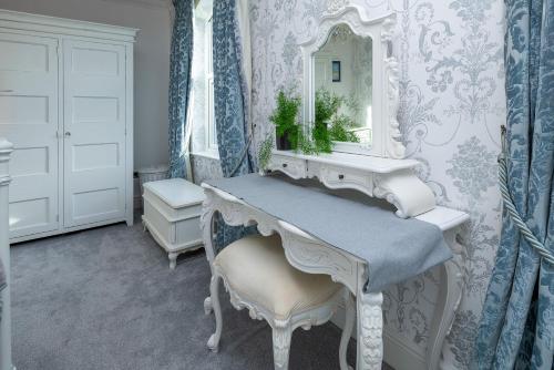 a bathroom with a white dressing table and a mirror at Snowdonia View in Llanfairpwllgwyngyll