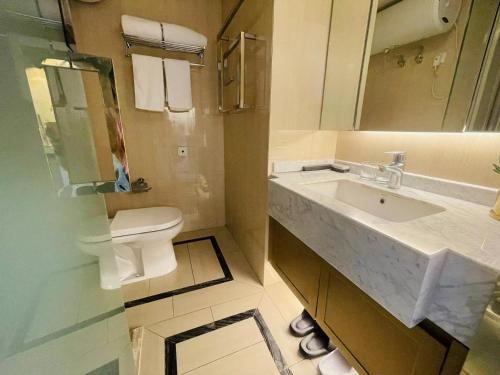 a bathroom with a sink and a toilet and a mirror at Shanghai Lerongju Boutique Apartment Metro Line 8 20meter in Shanghai