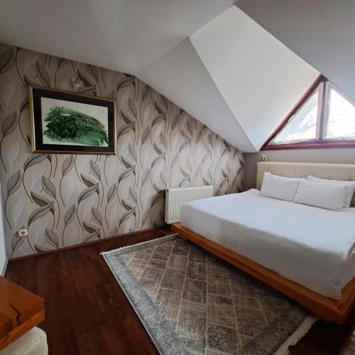 a bedroom with a large bed and a window at Aurora Resort & Spa in Berovo