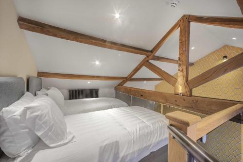 a bedroom with two bunk beds and a ladder at Rooms at The Vault in Buxton