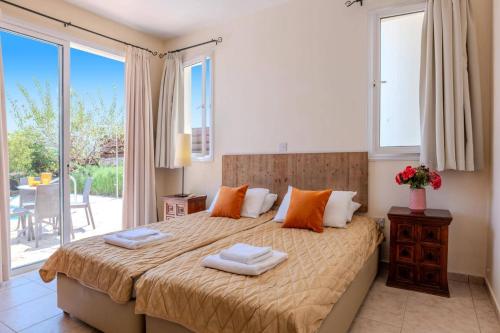 une chambre avec un grand lit avec deux serviettes dessus dans l'établissement Villa Oceana by Villa Plus, à Neo Chorio