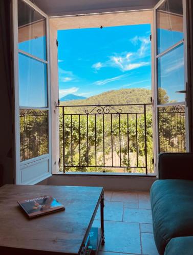a room with a large window with a view at La Grange du Barroux in Le Barroux