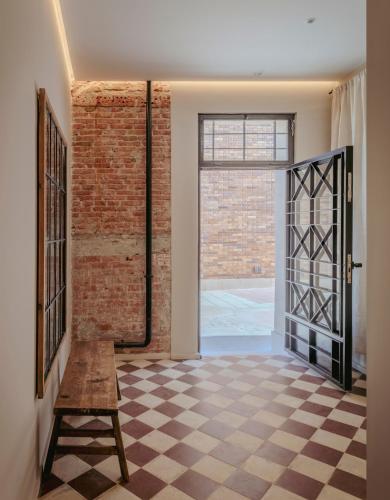 an open hallway with a brick wall and a door at CASA MARTINA Apartamentos de diseño en Pozuelo in Pozuelo de Alarcón