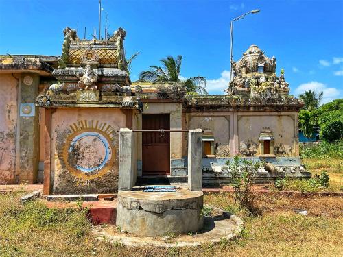 an old building with a gate in front of it at Golden Beach Hotel & Restaurant in Trincomalee