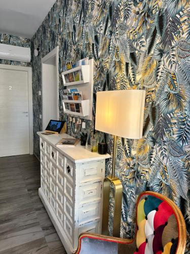 an office with a desk with a lamp and a chair at AlCivico3 in Civitanova Marche