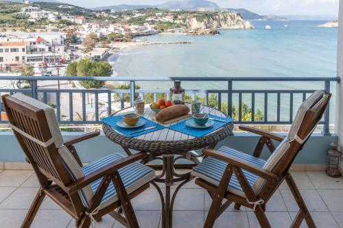 a table and chairs on a balcony with a view of the ocean at Almyrida Beach Bungalow Sea Front in Chania
