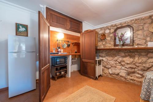 a kitchen with a white refrigerator and a sink at Ses Estaques in Manacor