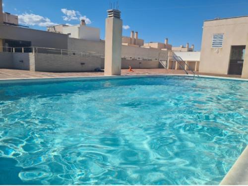 a large pool of blue water on top of a building at Appartement avec piscine in Puerto de Mazarrón