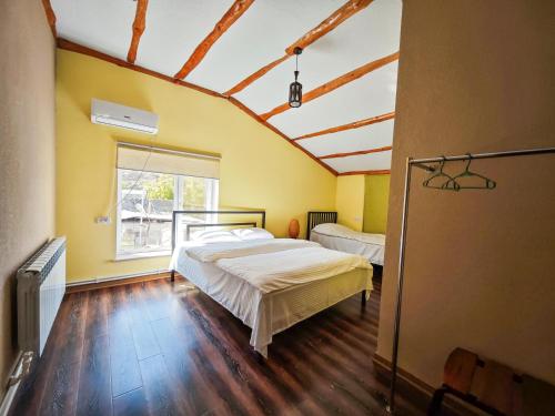 a bedroom with two beds and a window at Areni Wine Art in Areni