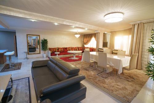 a living room with a couch and a table at Cozy apartment with stunning view near TGV station in Tangier