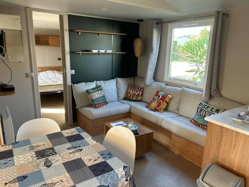a living room with a couch and a table at Lège-Cap-Ferret, confort et activités à 6 by Vayny in Lège-Cap-Ferret