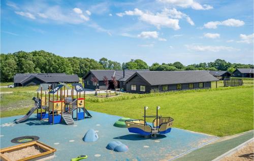a playground with two play equipment on a field at 9 Bedroom Beautiful Home In Sydals in Sarup
