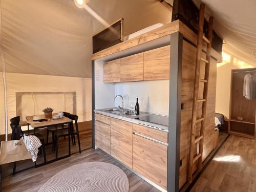 a kitchen with a sink and a table in a tent at Waterman Beach Village in Supetar